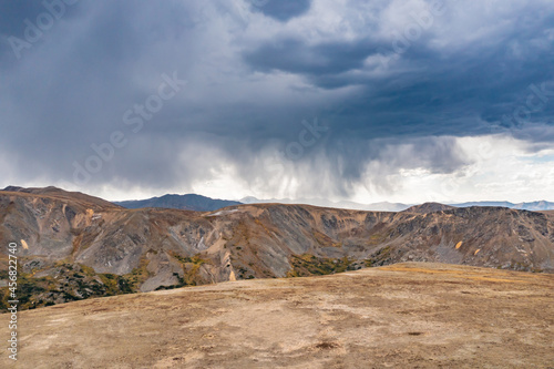 Developing thunderstorm with rain and virga over Rocky Mountains in Colorado, USA.