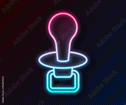 Glowing neon line Baby dummy pacifier icon isolated on black background. Toy of a child. Vector