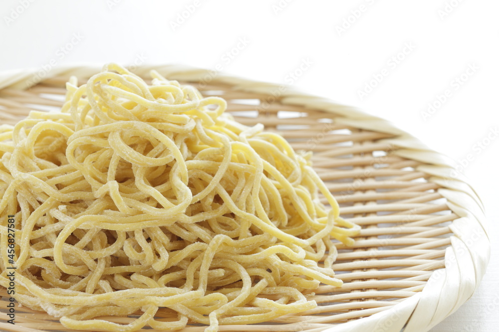 Chinese food ingredient, egg noodles and bamboo basket for ramen cooking image Chinese food ingredient, egg noodles and bamboo basket for ramen cooking image