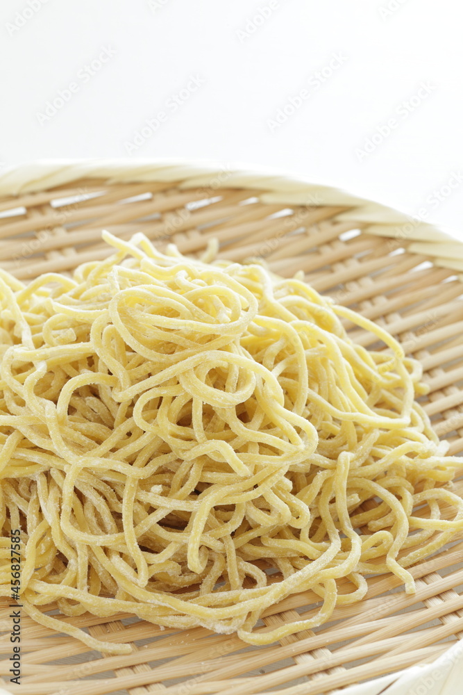 Chinese food ingredient, egg noodles and bamboo basket for ramen cooking image