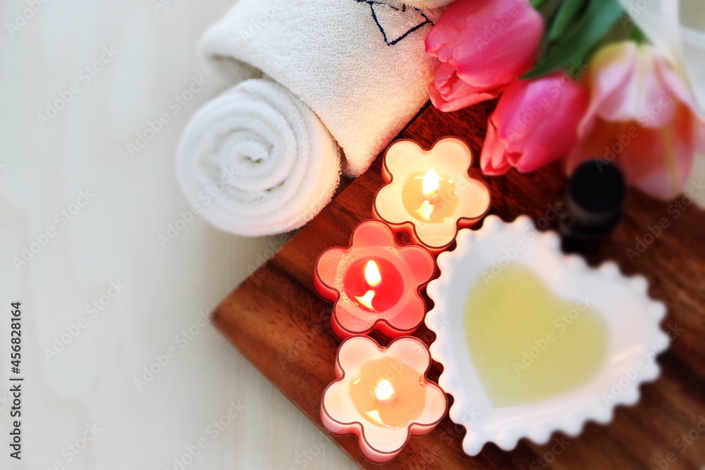 aroma candles and massage oil with towel