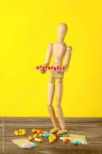 Wooden mannequin with pills...