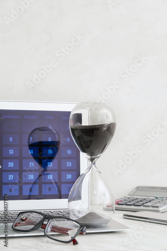 Hourglass, eyeglasses and l...
