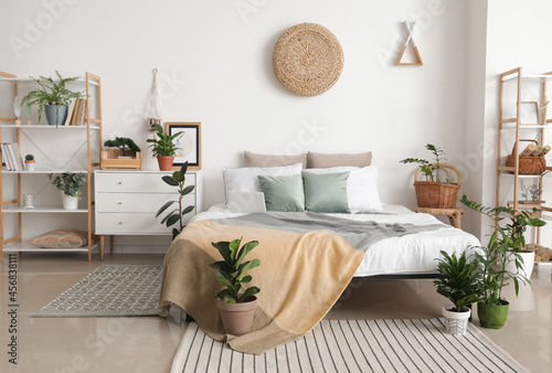 Interior of stylish bedroom with plants