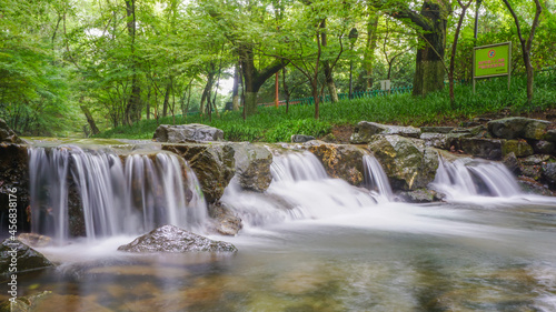 Waterfall and blue stream in the forest nature background for design, China