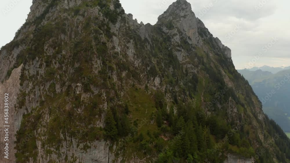 Climbing dron shot with a double speedramp revealing a climber hanging in a mountain wall in Switzerland Climbing dron shot with a double speedramp revealing a climber hanging in a mountain wall in Switzerland