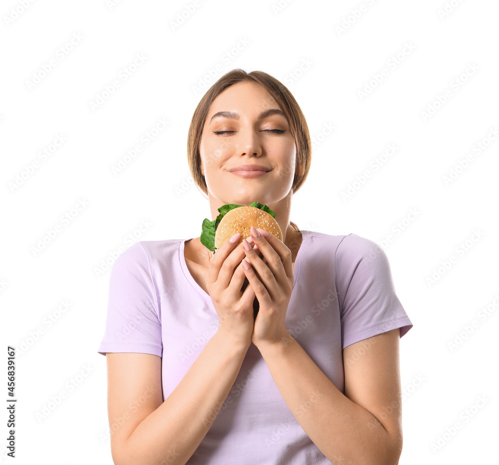 Beautiful young woman with tasty vegan burger on white background Beautiful young woman with tasty vegan burger on white background