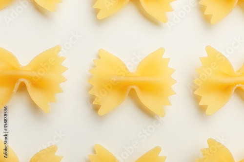 Uncooked farfalle pasta on light background