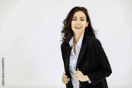Isolated portrait studio shot of Caucasian proud pretty smart professional success female businesswoman officer in black formal suit standing smiling and look at camera on white background