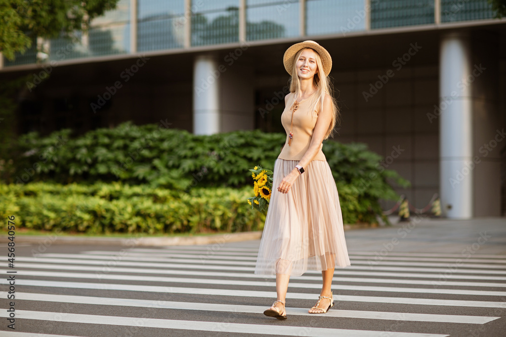 Portrait of beautiful woman with sunflowers outdoor at summer