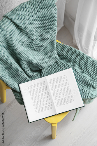 Chair with plaid and book i...