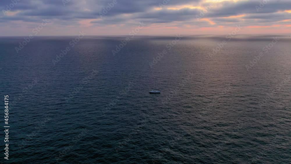 Flying towards a distant sailboat in the Pacific Ocean off the coast of Marina Del Rey California. Flying towards a distant sailboat in the Pacific Ocean off the coast of Marina Del Rey California.