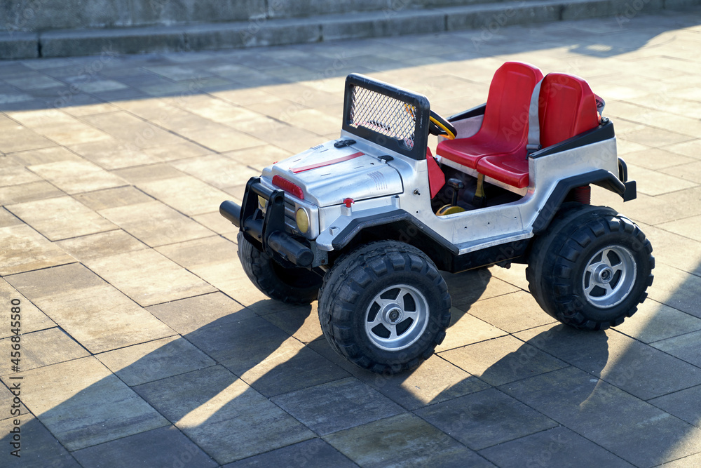 Plastic Toy car outdoor in the city in sunlight