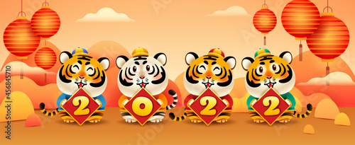Group of cute tigers with 2022 sign on oriental festive theme background. Wide copy space for design. © ori-artiste