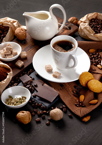 Coffee with snacks on black background.