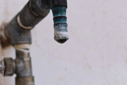 Fototapeta Naklejka Na Ścianę i Meble -  A faucet with a water drop closeup , Water consumption concept