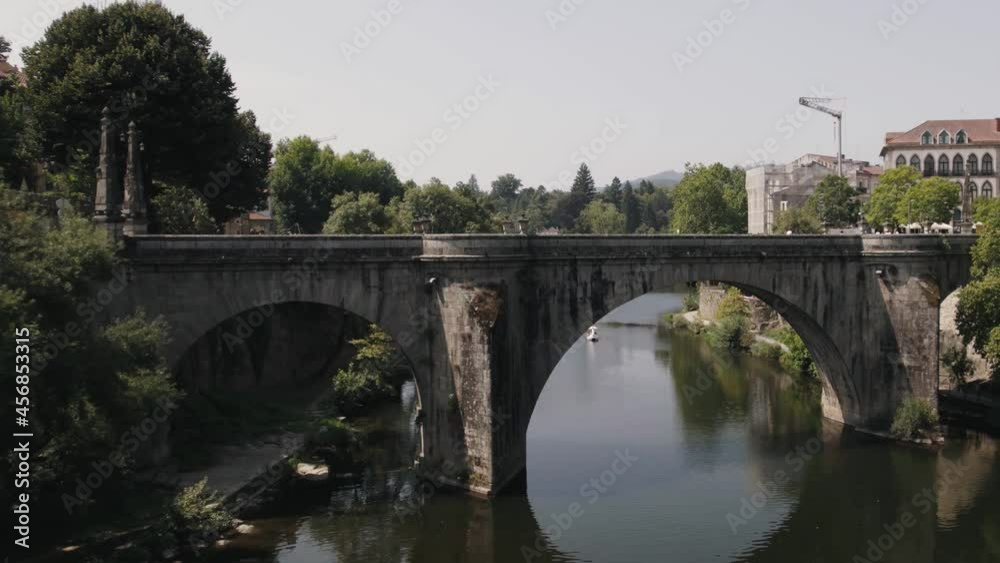 Aerial pull out shot of baroque and neoclassical style Sao Goncalo bridge and water reflection. Aerial pull out shot of baroque and neoclassical style Sao Goncalo bridge and water reflection.
