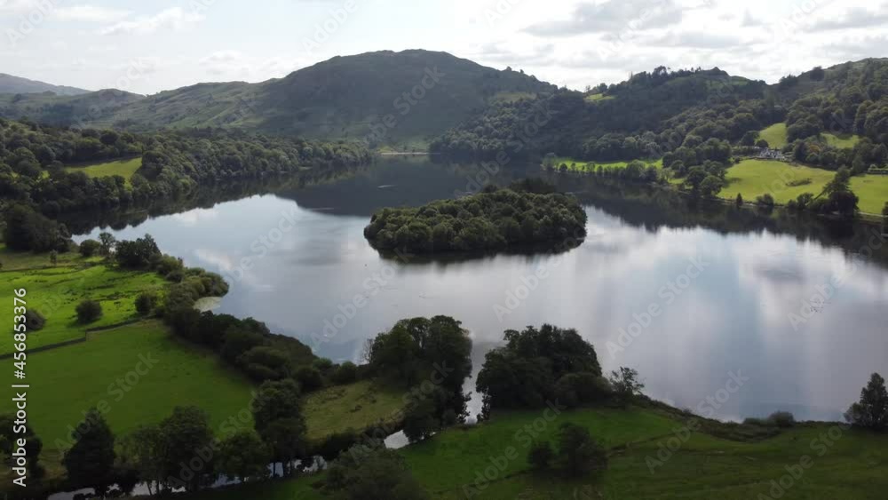 Drone view Grasmere ( the Lake) Cumbria England 4K clouds and blue sky reflected on surface Drone view Grasmere ( the Lake) Cumbria England 4K clouds and blue sky reflected on surface