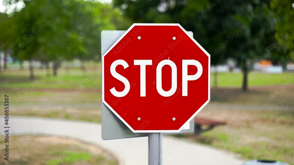 Stop road sign, handheld movement, blurred background, gimbal shot Stop road sign, handheld movement, blurred background, gimbal shot