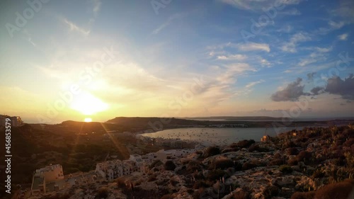 Timelapse video from Malta, Mellieha Heights location towards the stunning landscape and bay at sunset. photo