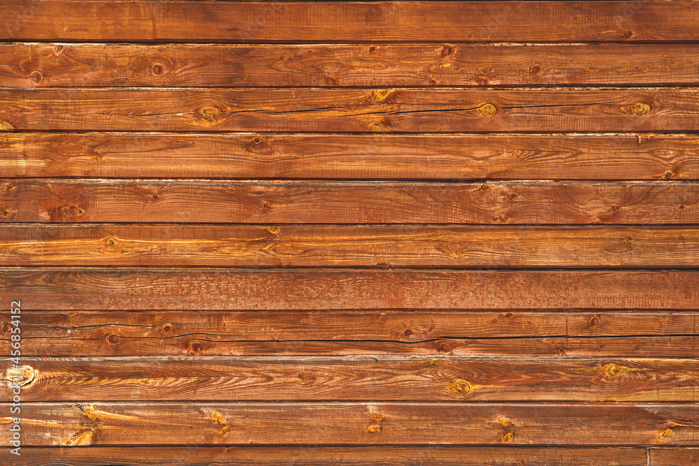 The wall of the house is made of old brown timber. The wall of the house is made of old brown timber.