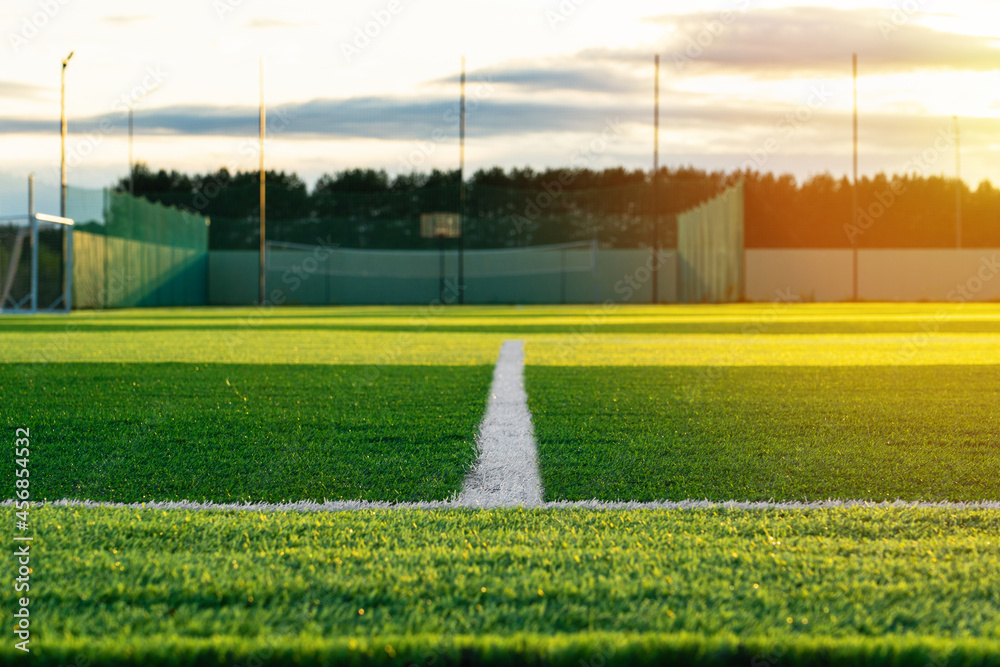 Obraz premium A white line on a football field covered with synthetic plastic lawn