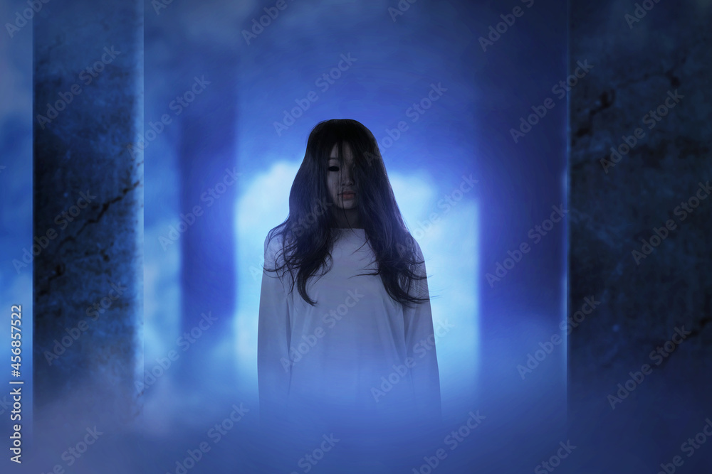 Fototapeta premium Scary ghost woman standing in the abandoned building