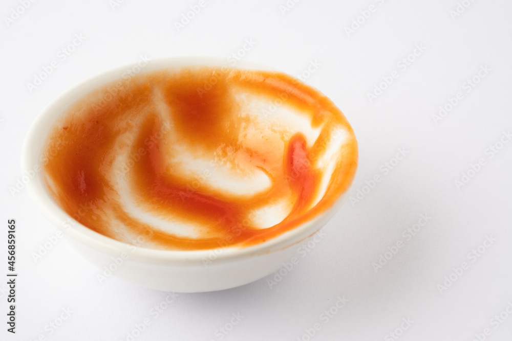 Tomato ketchup in ceramic bowl on white background. Tomato ketchup in ceramic bowl on white background.