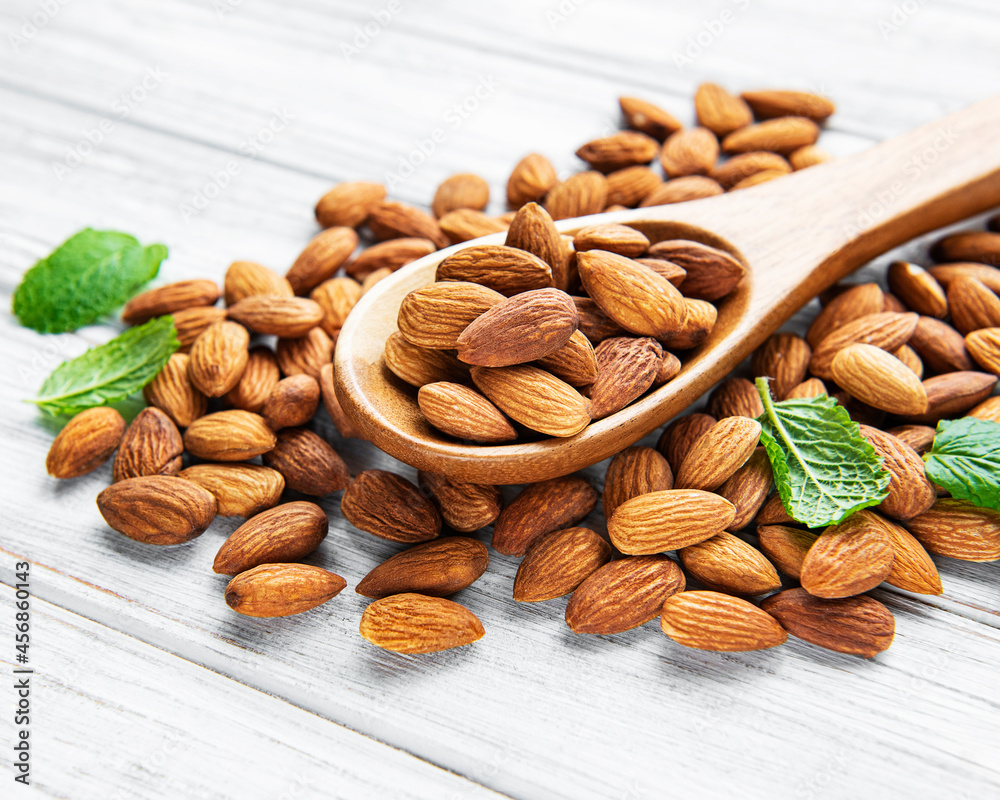 Almonds in brown spoon Almonds in brown spoon