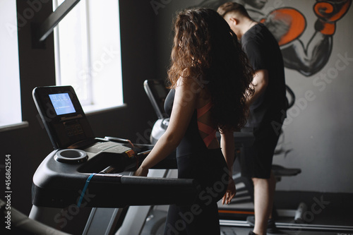 Woman is engaged in a gym with coach