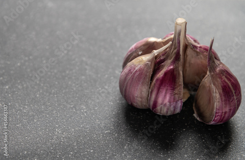 organic garlic cloves close up on dark background