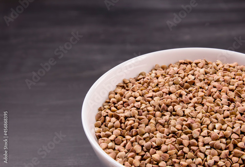 Uncooked organic buckwheat grains in bowl