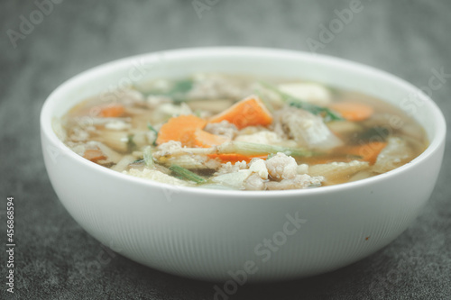 Big bowl of clear soup with vegetables and minced pork