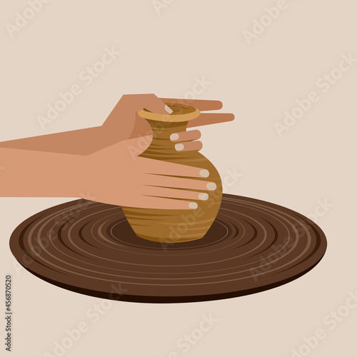 Traditional pottery making with hand shaping a pot on a spinning wheel