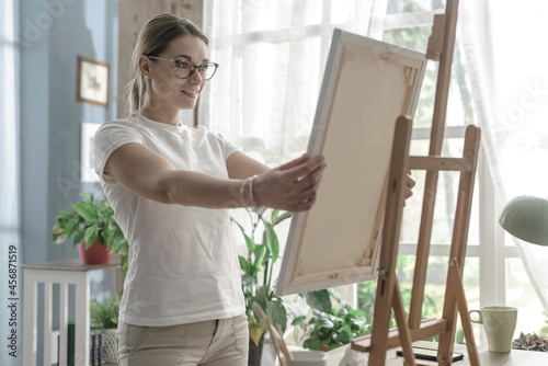 Happy woman holding her finished artwork