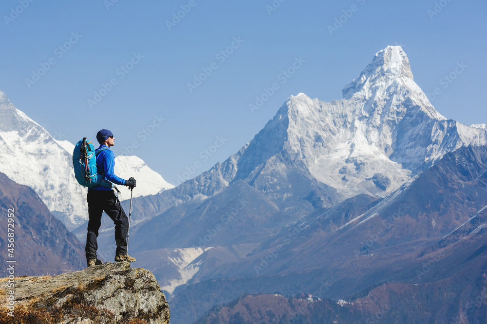 Hiker enjoying the view on the Everest trek in Himalayas, Ama Dablam mountain view, Nepal