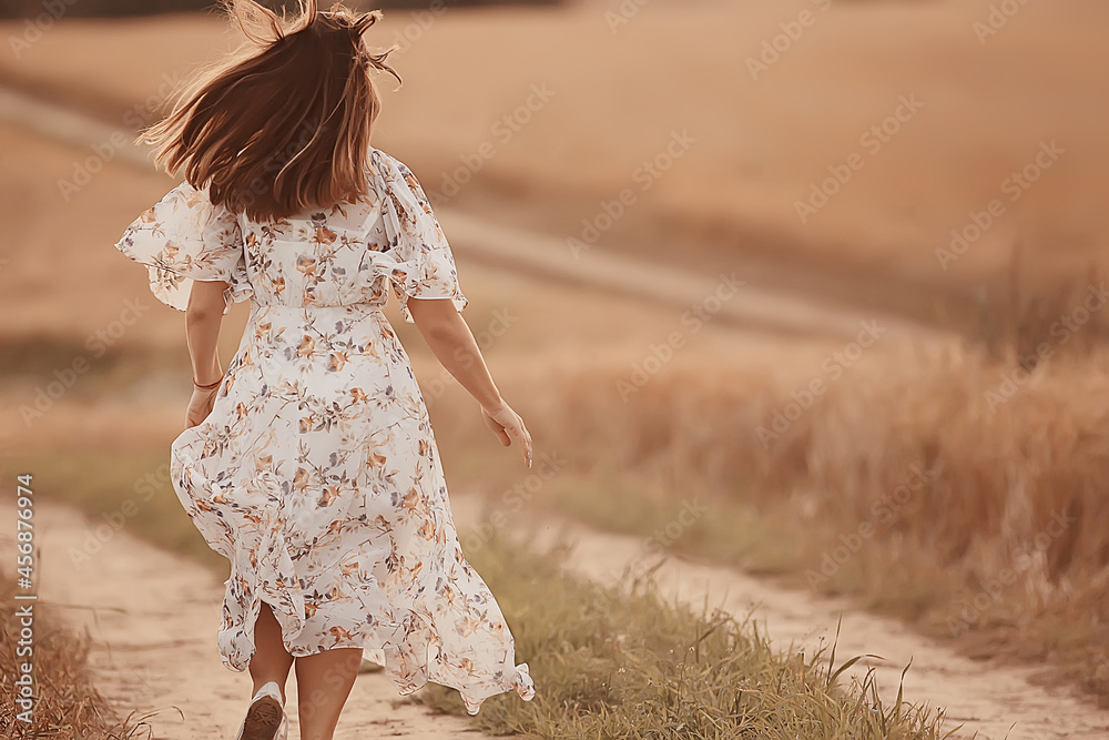 girl runs on a summer field in a dress wheat, sunset sunny day concept freedom happiness girl runs on a summer field in a dress wheat, sunset sunny day concept freedom happiness
