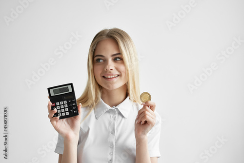 cheerful woman in a white shirt with a folder in hand light background