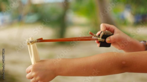 Girl shoots with a slingshot
