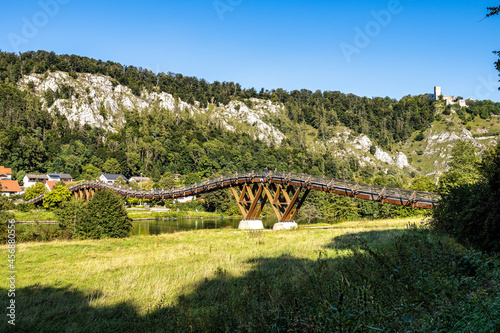 Wooden bridge Tatzelwurm in Essing at Altmuehl river below the ruins of Randeck Castle, Bavaria, Germany photo
