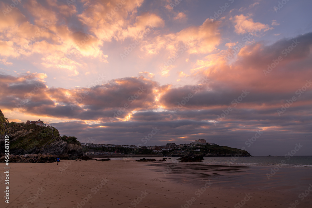 Beautiful cloudscape over the beach at Newquay, Cornwall, as the sun sets