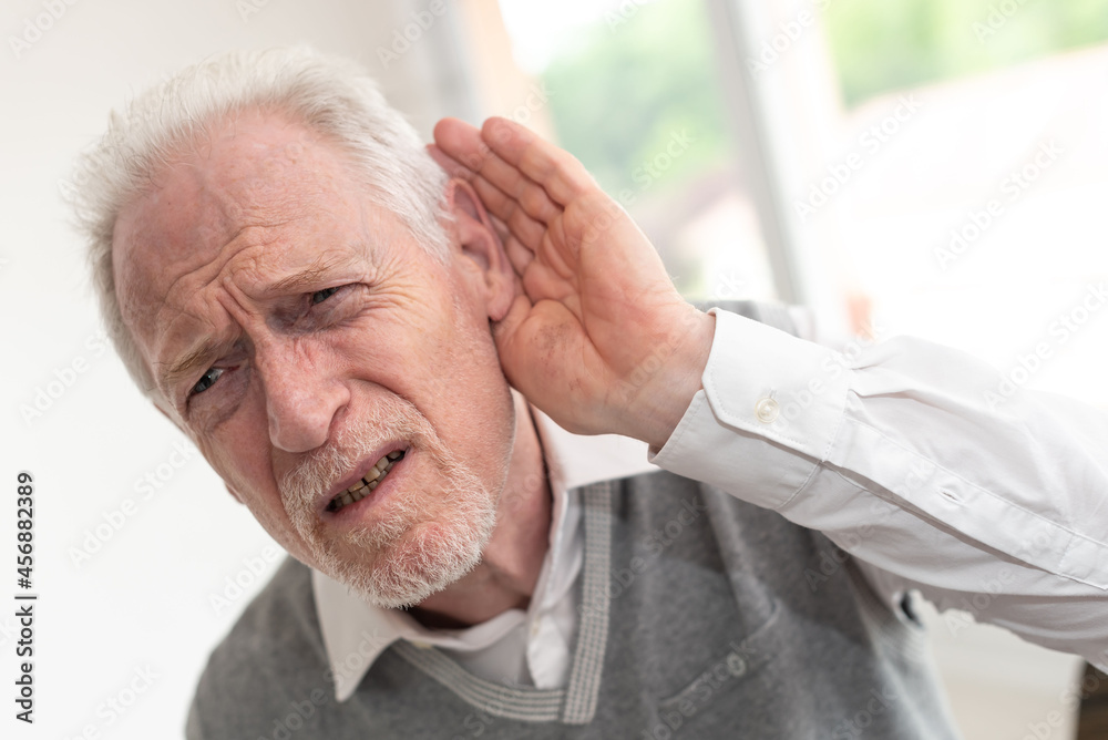 Senior man with hearing problems Senior man with hearing problems