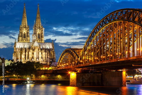 Cologne Cathedral city skyline and Hohenzollern bridge with Rhine river in Germany at twilight
