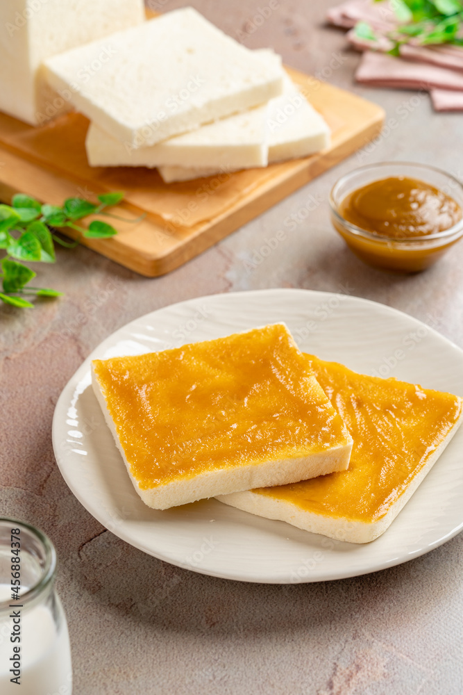 Sliced White Bread with kaya Jam. Coconut jam, also known as kaya jam, is a sweet spread made from a base of coconut milk, eggs and sugar.