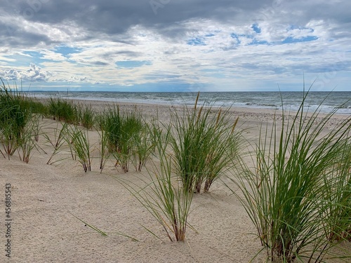 Fototapeta Naklejka Na Ścianę i Meble -  White sand dunes with some grass and seascape background