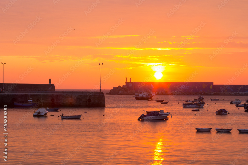 Sunset on the sea with fishing boats