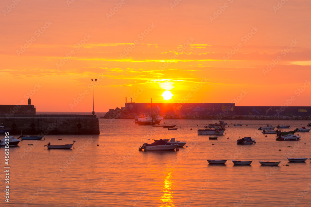 Sunset on the sea with fishing boats