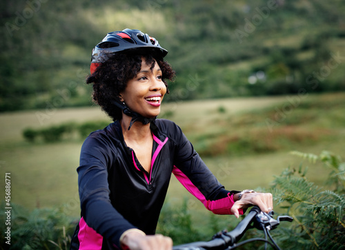 Cheerful female cyclist enjoying a bike ride photo