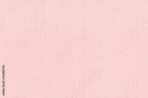 Pink-dyed fabric texture background. Plain pattern textile backdrop. 