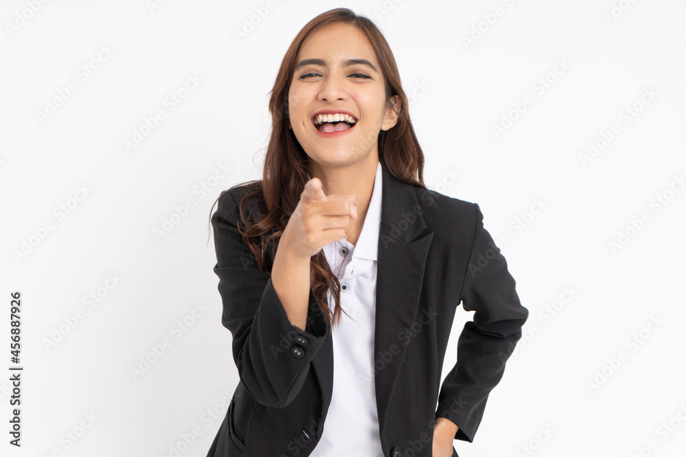 young businessman wearing suit pointing at camera with offensive laughing expression young businessman wearing suit pointing at camera with offensive laughing expression